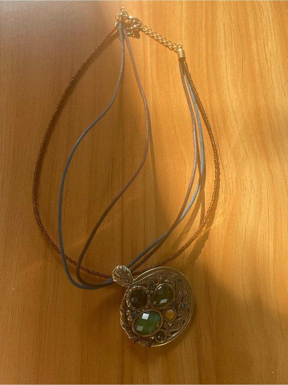 Multistrand Gold Pendant Necklace with Green and Amber Gemstones